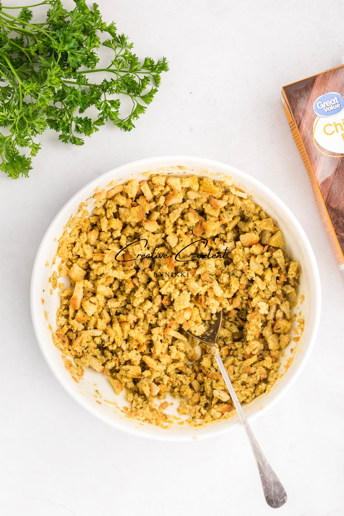 Bowl of seasoned breadcrumbs for Church Cookbook Chicken Casserole with parsley and Great Value box
