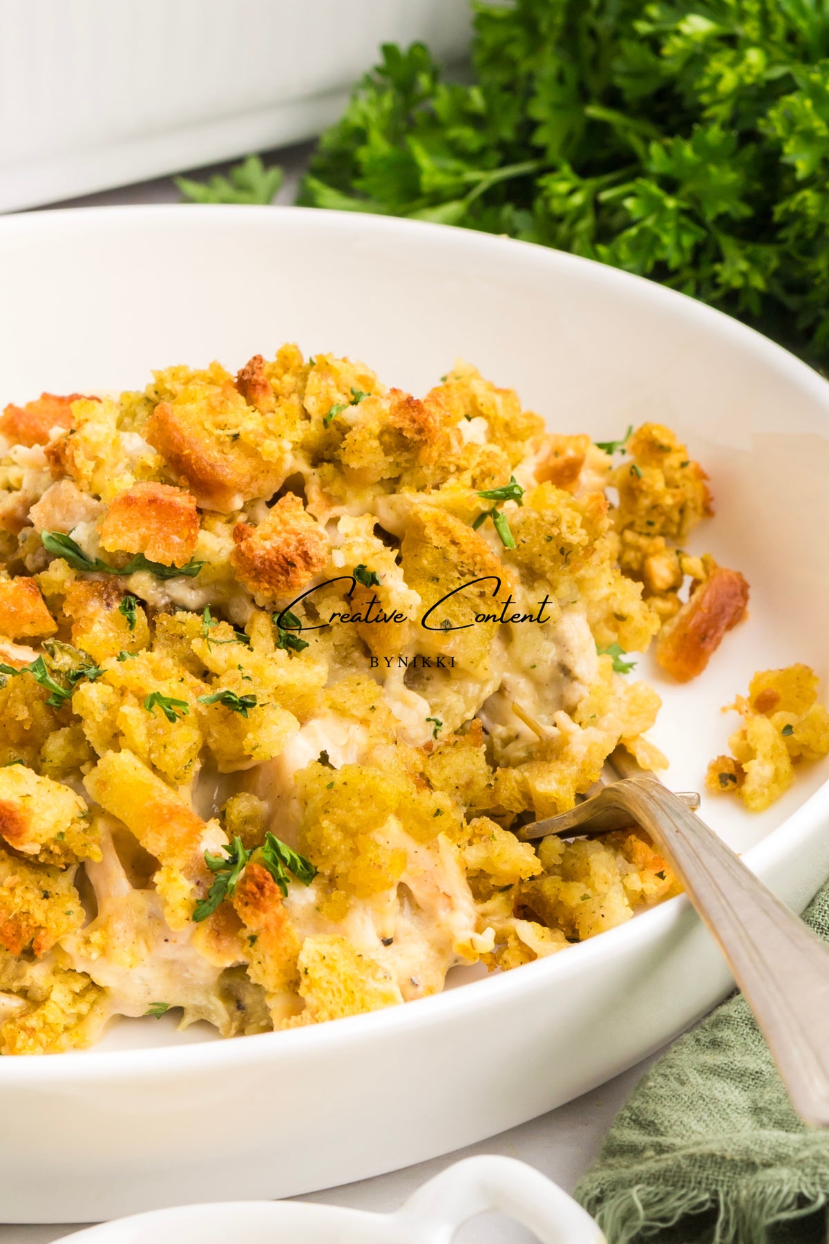 Church cookbook chicken casserole with a breadcrumb topping in a white bowl