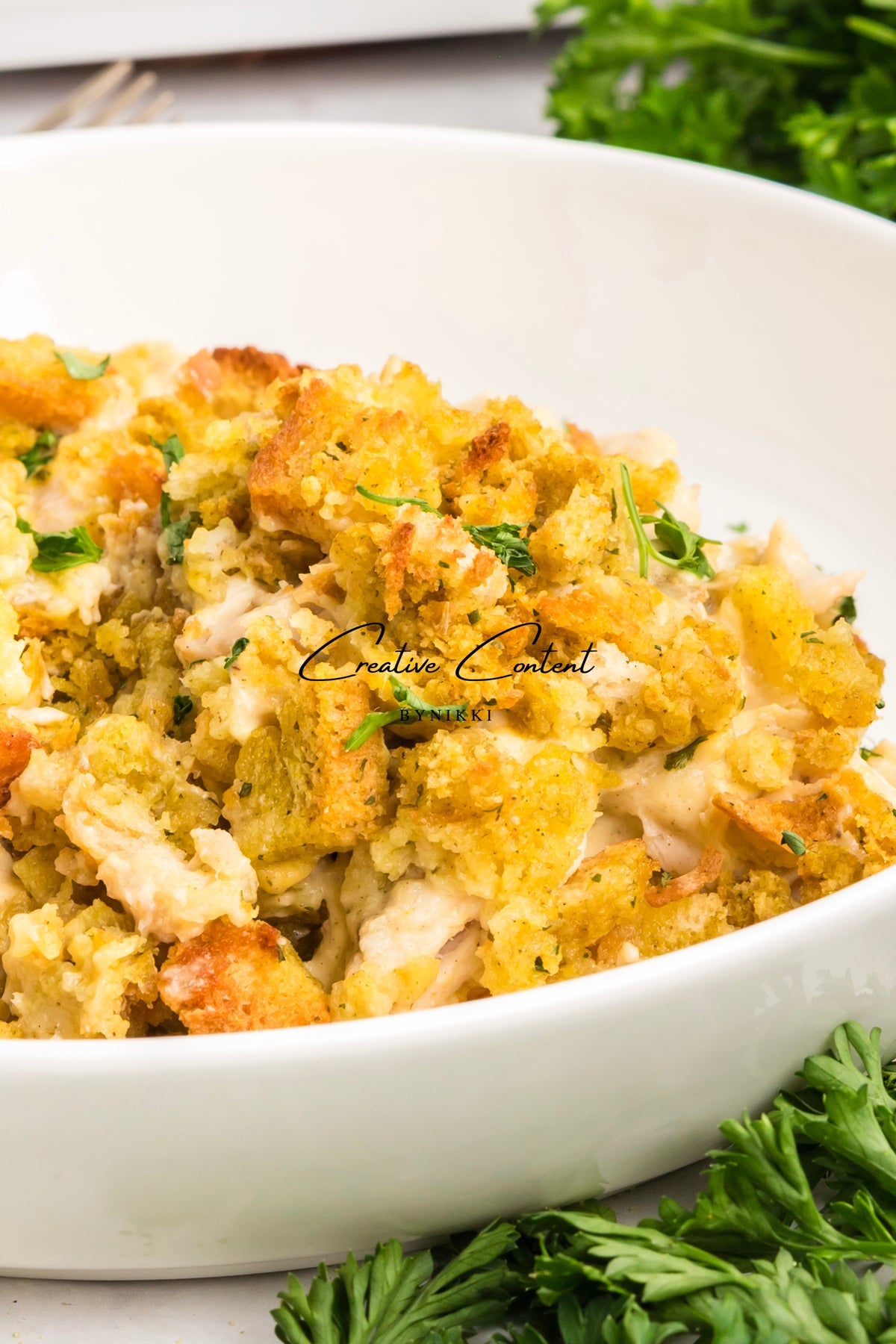 Church cookbook chicken casserole with a golden breadcrumb topping in a white bowl