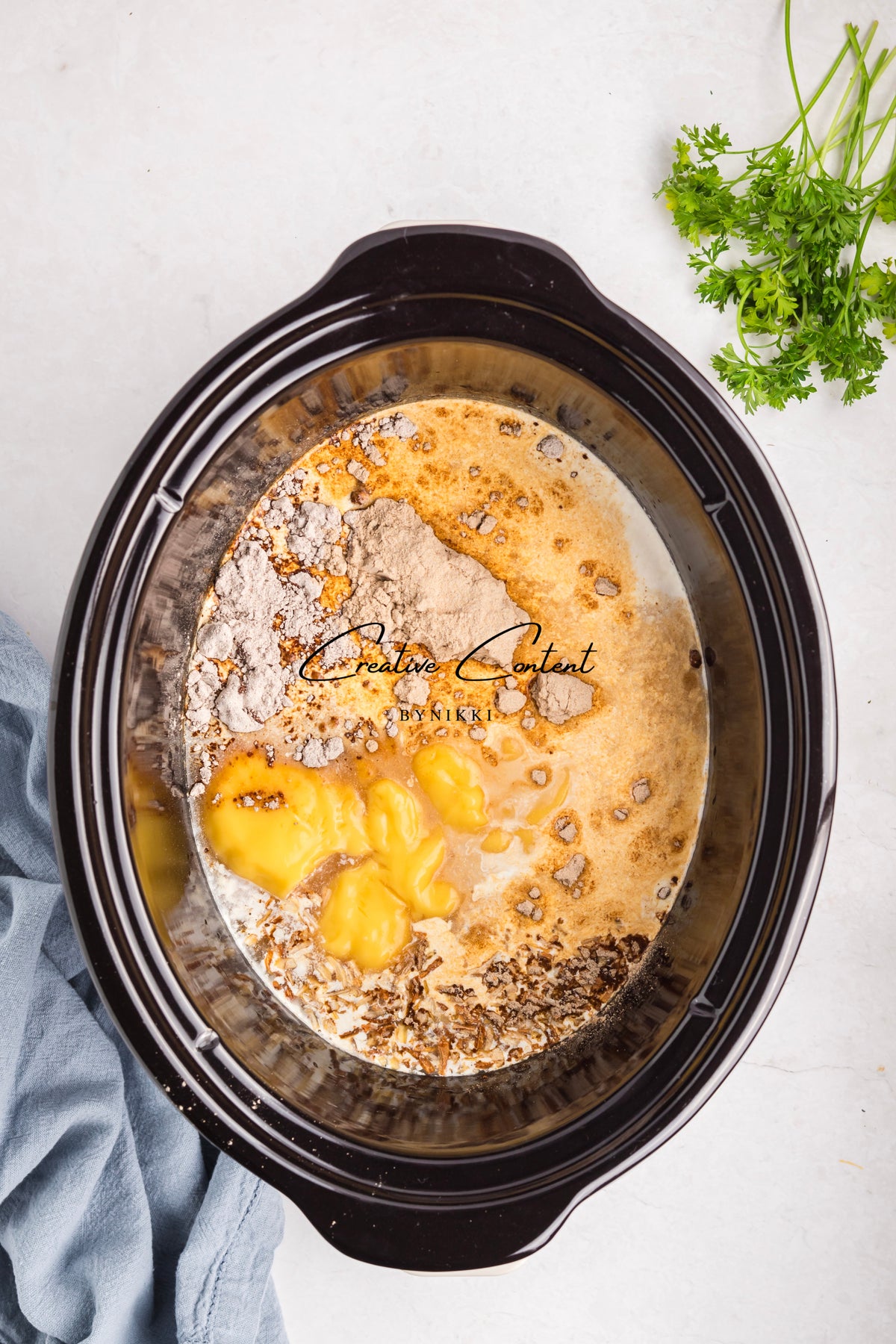 Ingredients for Crock Pot Smothered Meatballs and Green Beans - Exclusive, including dry seasonings, canned soup, and sauce, inside a slow cooker.