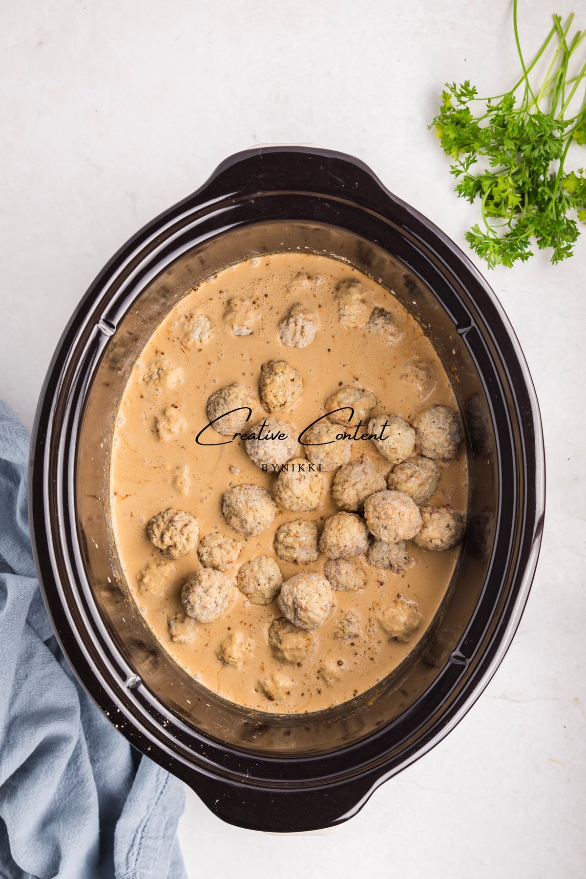 Crock Pot Smothered Meatballs and Green Beans - Exclusive simmering in a creamy sauce.