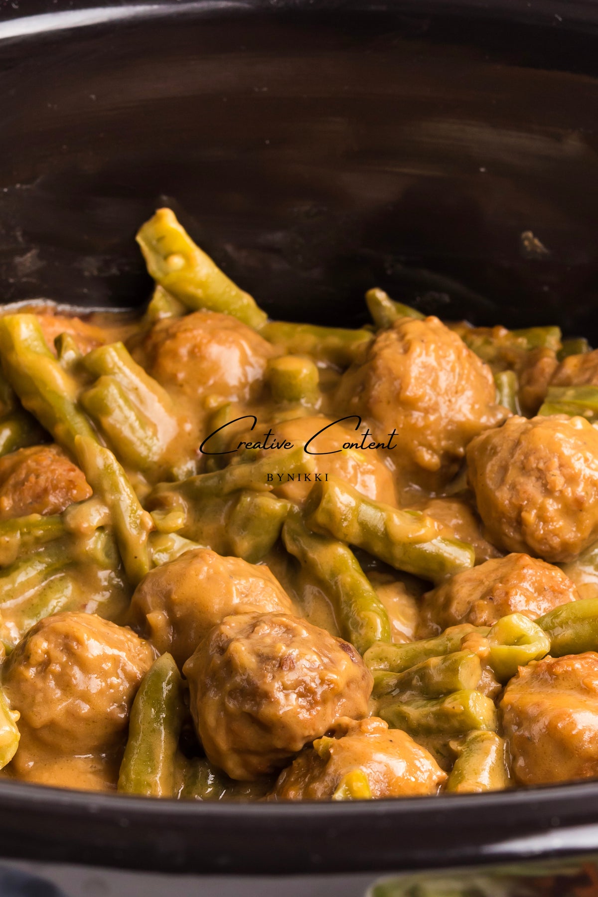 Crock Pot Smothered Meatballs and Green Beans simmered in a creamy brown sauce.