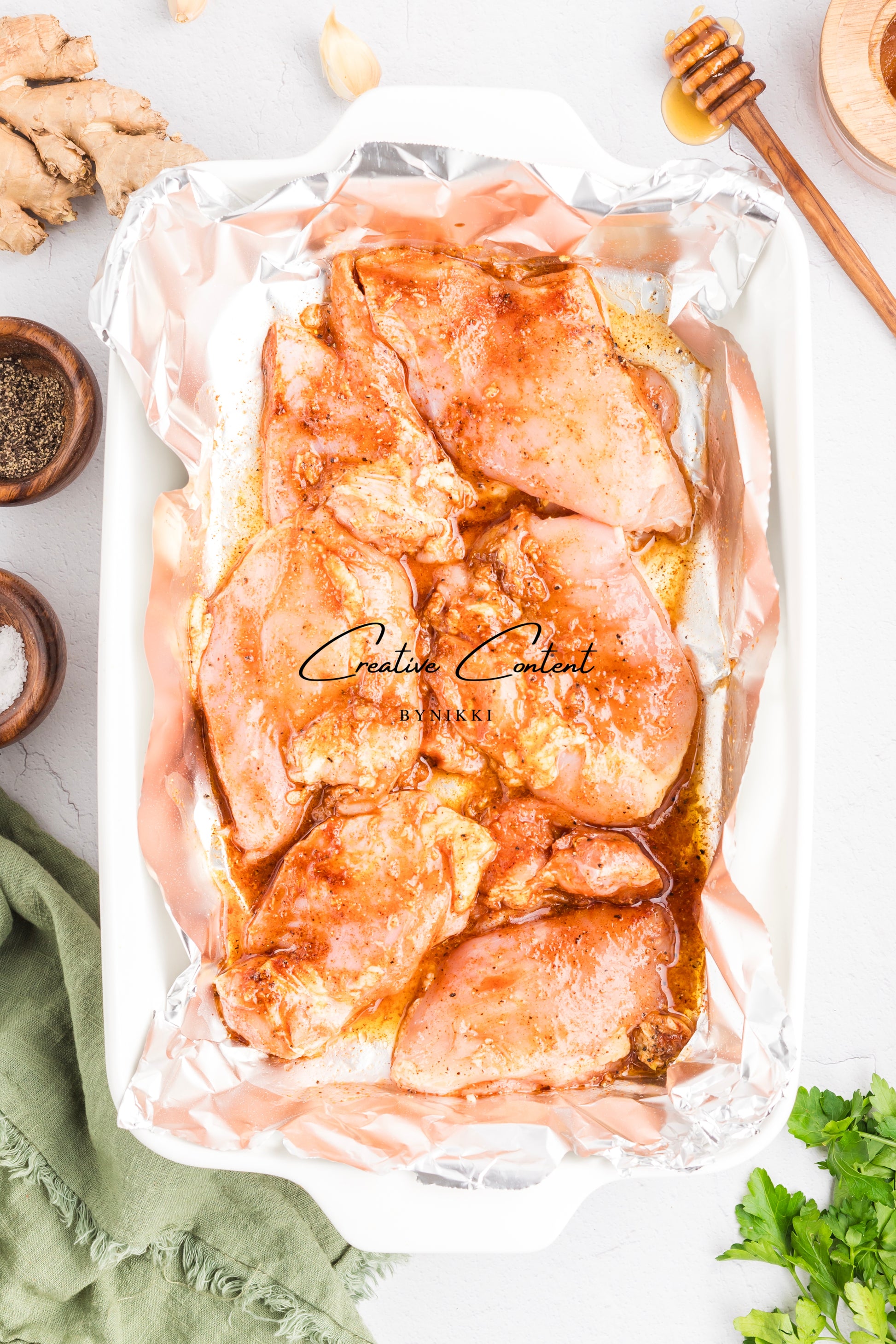 raw chicken in a baking dish coated in the seasonings. 