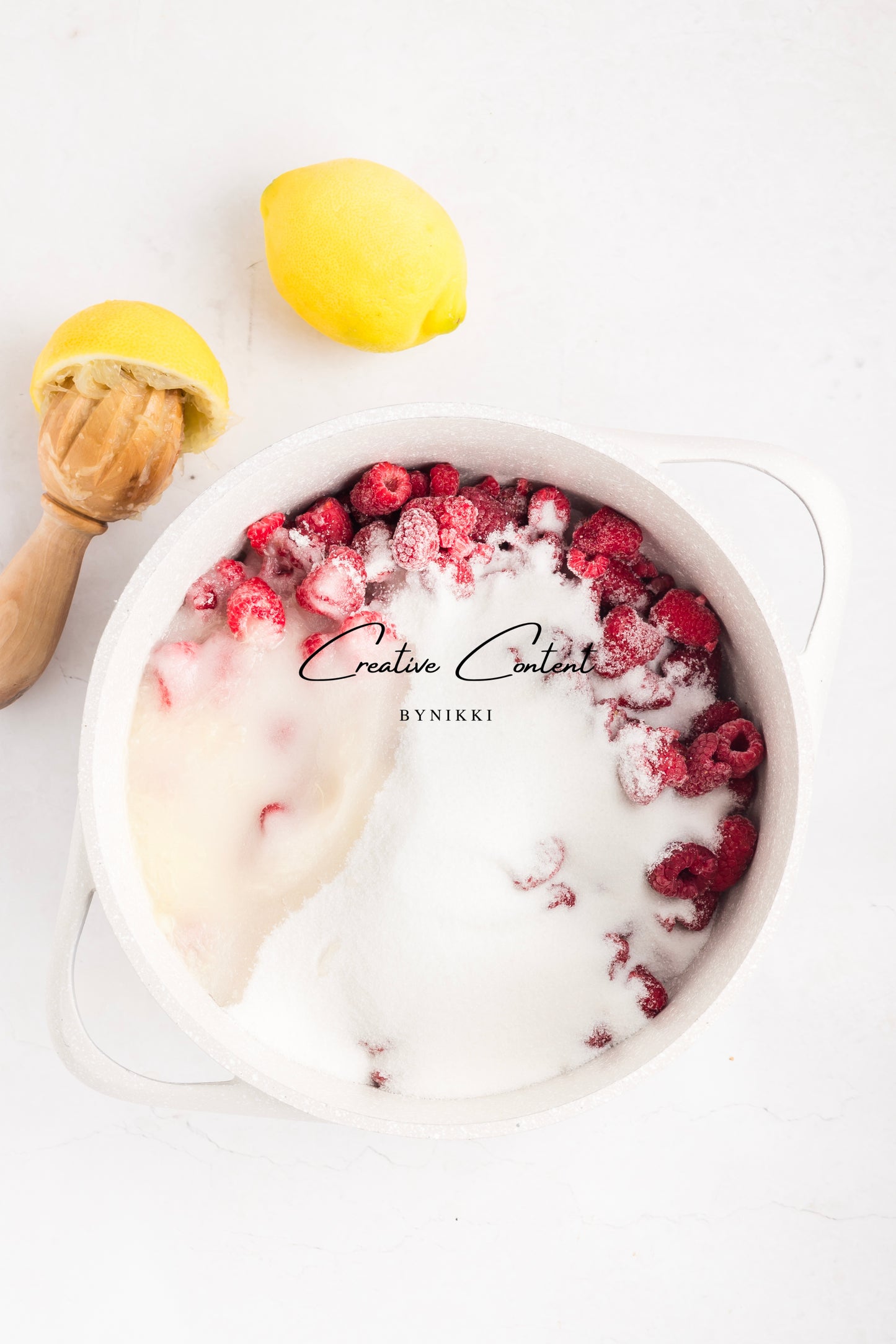 sugar with raspberries and lemon slices on a white background